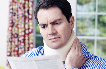 Man with whiplash reads medical records